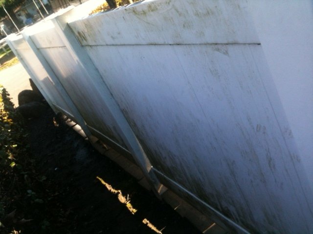 Wood fence covered in dirt and grime before pressure washing